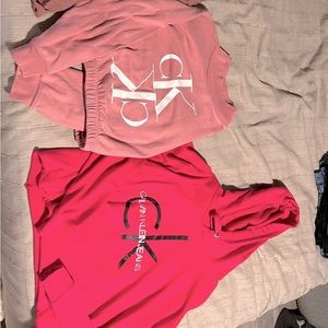 Two Calvin Klein cropped sweatshirts